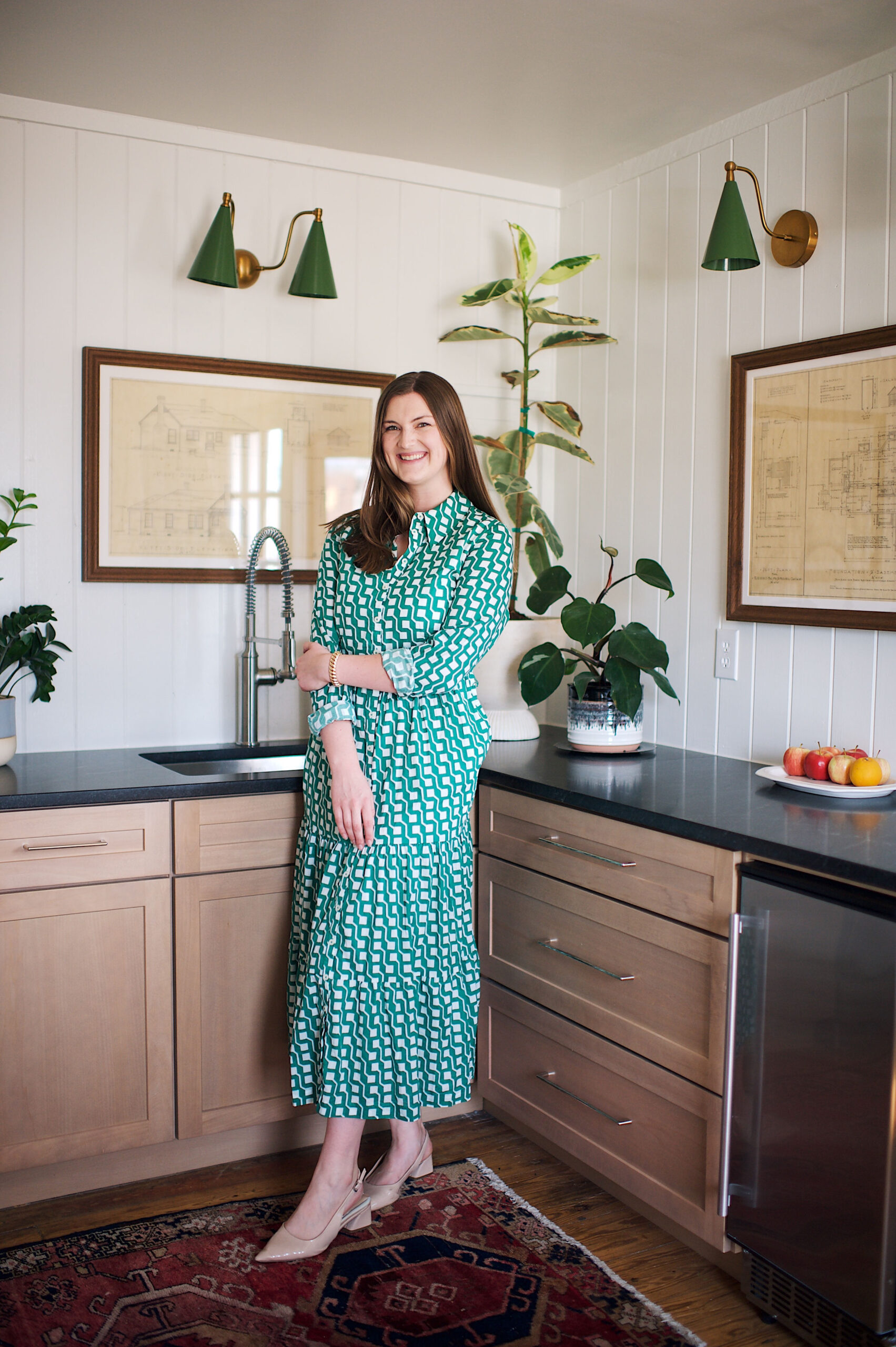 Sami Lamb reviewing closing documents with a client in a bright, modern space